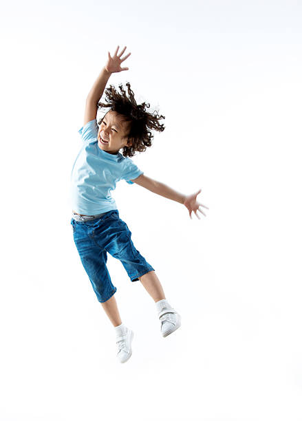 istock Little boy jumping isolated on white background 614845024