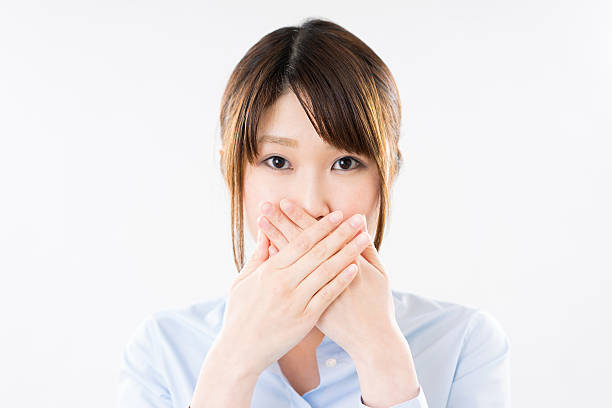 istock Businesswoman with hands over mouth 614845264