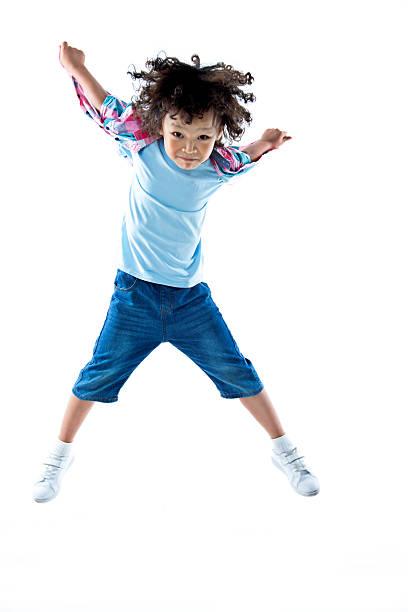istock Little boy jumping isolated on white background 614845560