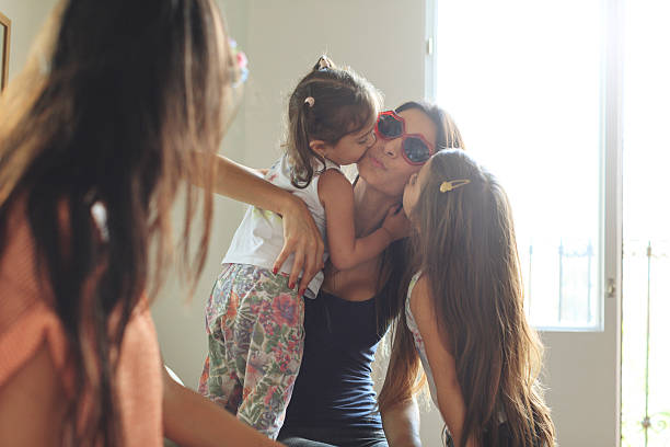 istock Mothers and daughters having fun together at home 614846346