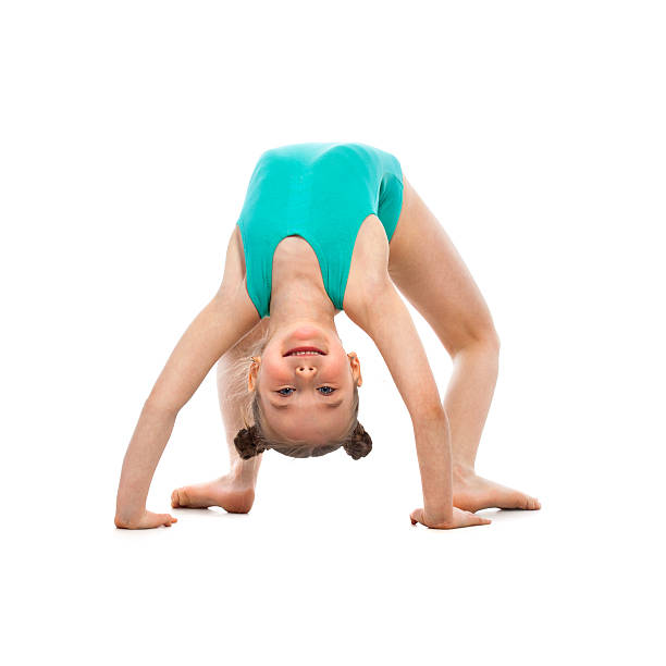 istock Flexible little girl gymnast doing a bridge on white background 614847220