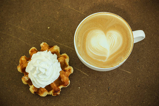 Hot coffee cafe latte with waffle and cream