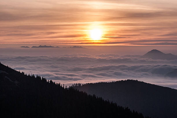 istock sunrise above autumn Tatras mountains with misty bellow 614848224