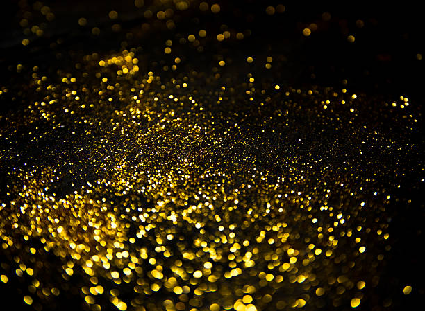istock gold glitter lights on black background. 614848322