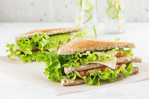 istock Sandwich with lettuce, cheese, tomato and lemonade 614848422