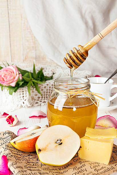 istock Breakfast with delicious sweet honey, tea, cheese and pear 614849446