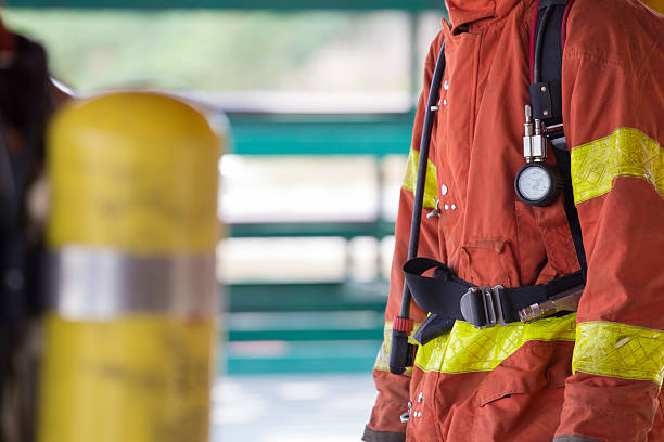 istock close up fireman in fire fighting protection suit and equipment 614850080