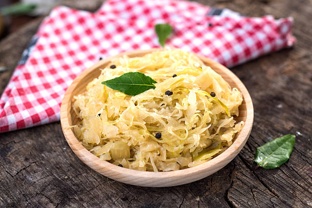 istock Steamed sauerkraut on old wooden background 614850118