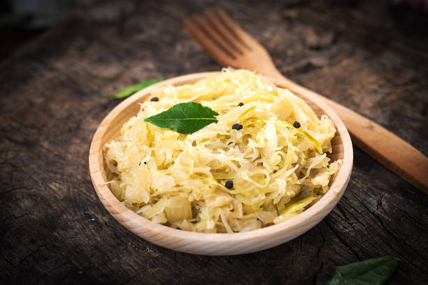 istock Steamed sauerkraut on old wooden background 614850280