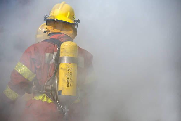 fireman in operation surround with smoke stock photo