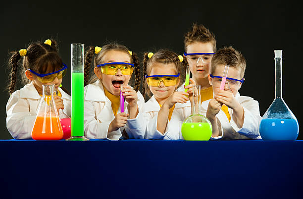istock Funny kids in the laboratory. Science and education in lab 614850418