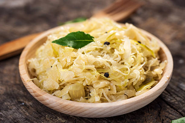 Steamed sauerkraut on old wooden background Steamed sauerkraut on old wooden background german food photos stock pictures, royalty-free photos & images
