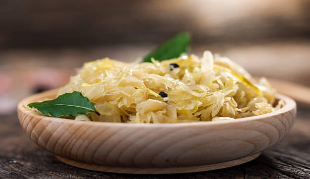 istock Steamed sauerkraut on old wooden background 614850938