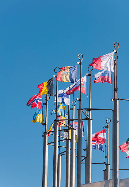 istock Row of national flags against blue sky 614851620