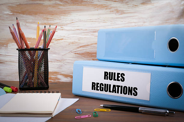 istock Rules And Regulations, Office Binder on Wooden Desk 614851920