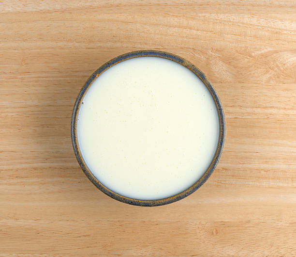istock Bowl of buttermilk on a wood table 614852186