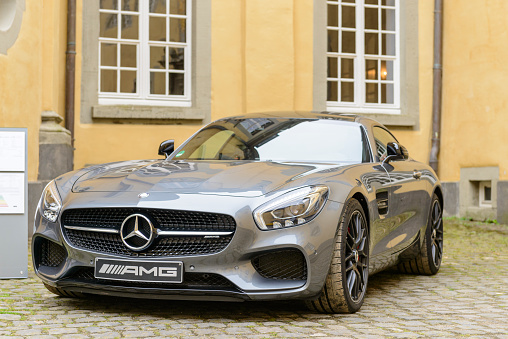 Jüchen, Germany - August 5, 2016: Gray Mercedes-AMG GT coupe performance  sports car front view. The Mercedes AMG GT is powered by a front-mid mounted 4-litre twin-turbo V8. The car is on display during the 2016 Classic Days at castle Dyck. 