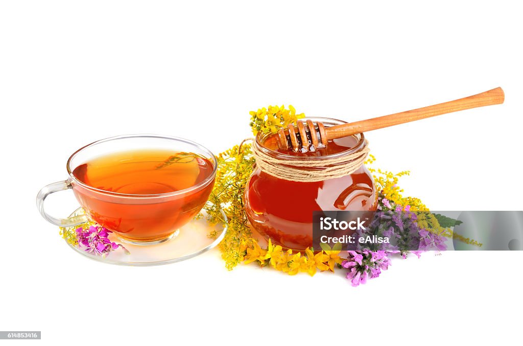Flowers with tea and honey Fresh herbal honey, black tea and color flowers on white background Black Tea Stock Photo