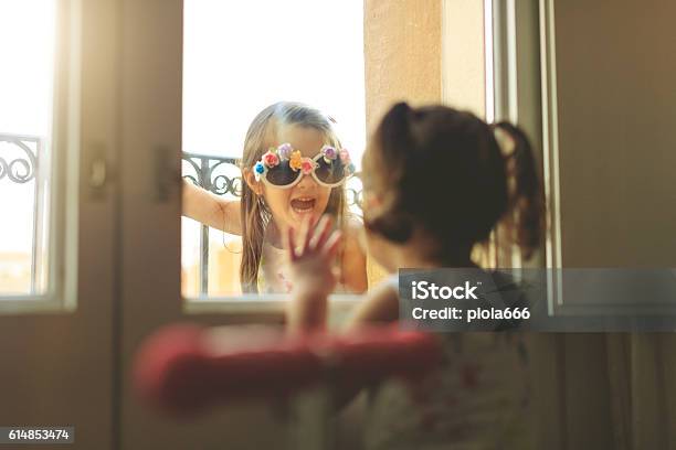 Baby Girls Together By A Window Stock Photo - Download Image Now - Eccentric, Lifestyles, Adult