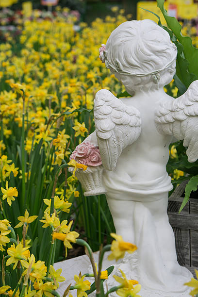 istock statue of little child with angel wings which faces a 614853582