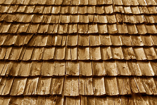 istock Weathered wooden tile roof texture. 614854744