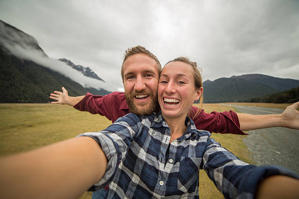 istock Two young adults taking selfie portrait in nature 614854888