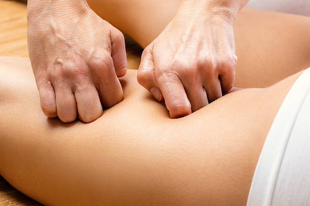 istock Detail of hands massaging female hamstring. 614855256