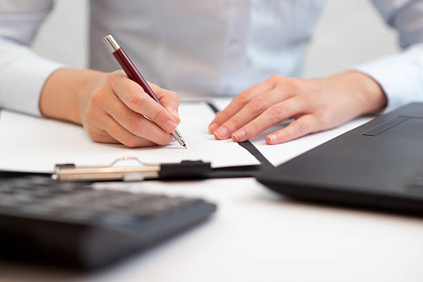 istock Busy woman taking some important notes, account and finance 614856342