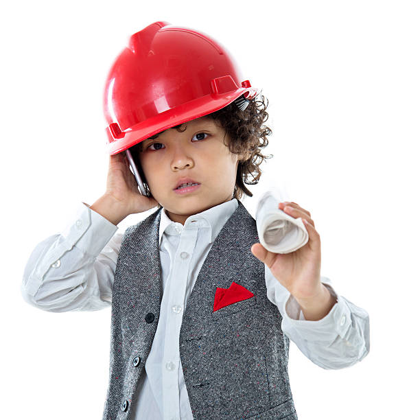 istock Little engineer with helmet and blue prints 614856358