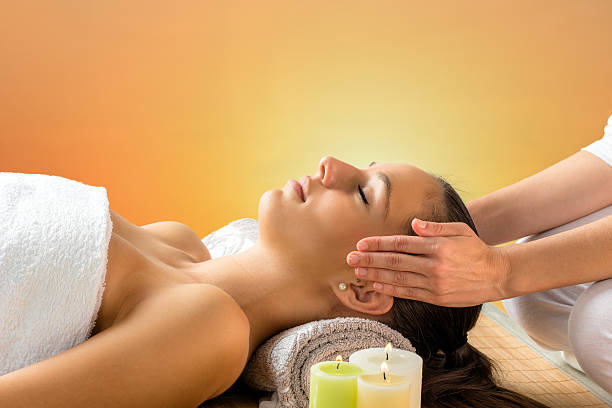 istock Reiki therapist doing treatment on woman. 614856666