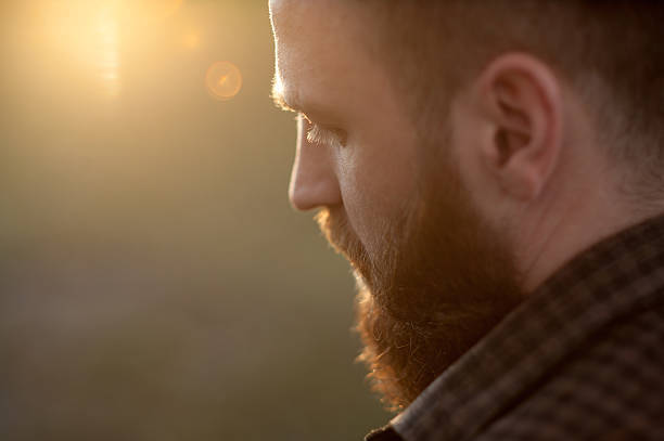 istock close-up of a young bearded man with back side view 614857650