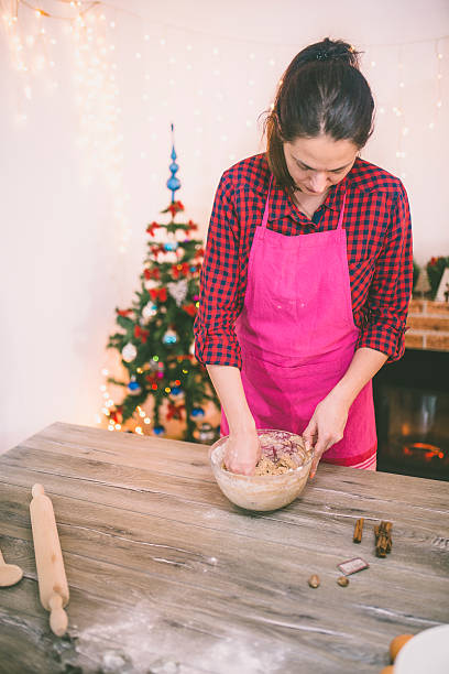 istock woman making gingerbread and cookies 614858296