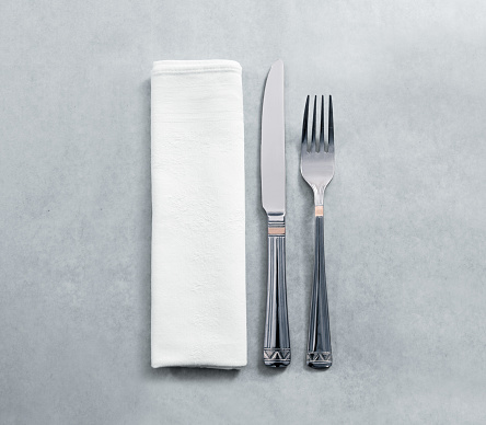Blank white restaurant napkin mockup with knife and fork, isolated. Cutlery near clear textile towel mock up template. Cafe branding identity clean napkin surface for logo design.