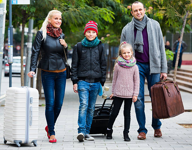 istock Parents with two kids chasing streets 614859848