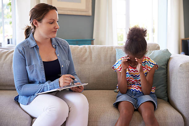 istock Young Girl With Problems Talking With Counselor At Home 614860044