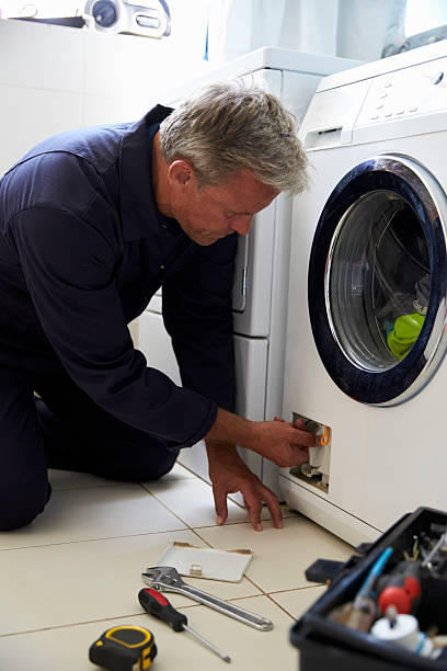istock Plumber Fixing Domestic Washing Machine 614860176