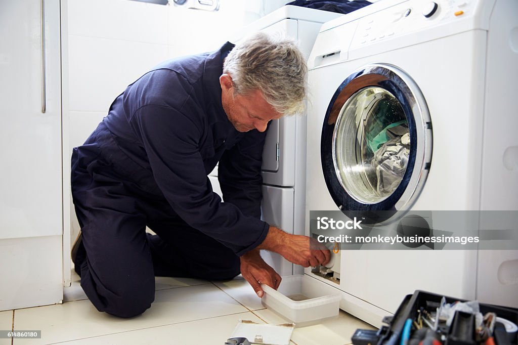 Plumber Fixing Domestic Washing Machine Repairing Stock Photo