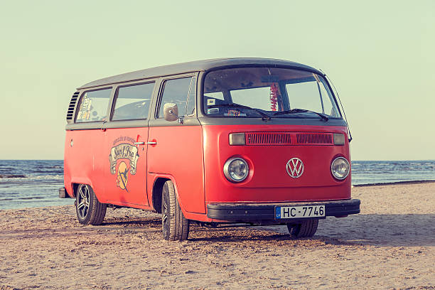 Jurmala, Latvia - May 28, 2016: vintage red volkswagen bus on beach near the Baltic Sea. Jurmala, Latvia. Retro styled photo.