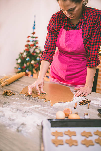istock woman making gingerbread and cookies 614861404