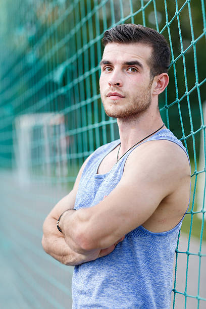 istock Sports guy standing with arms crossed and looking at camera 614861826