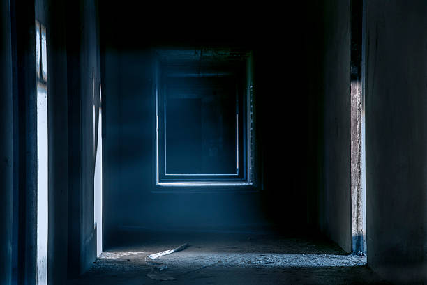 istock Creepy night walkway hallway in abandoned building 614861828