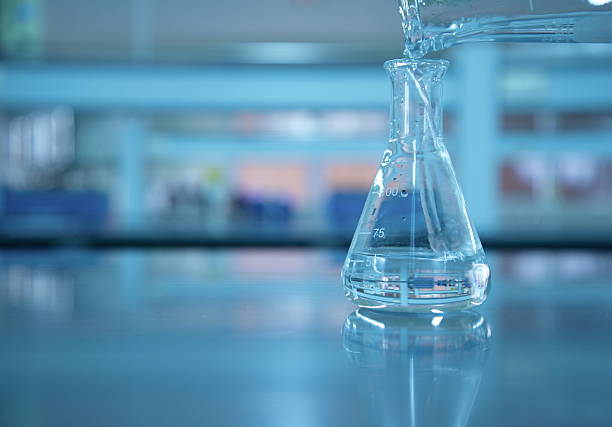 istock water poring in the flask at lab science 614862930