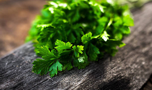 istock Fresh green parsley on  wooden background 614863396
