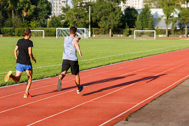 istock Two athletic men compete who runs faster 614863572