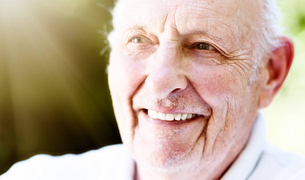 istock Old man smiles in delight, happy with his life 614864174