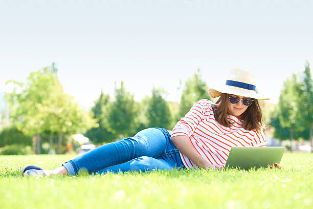 istock Young woman with laptop outdoor 614864340