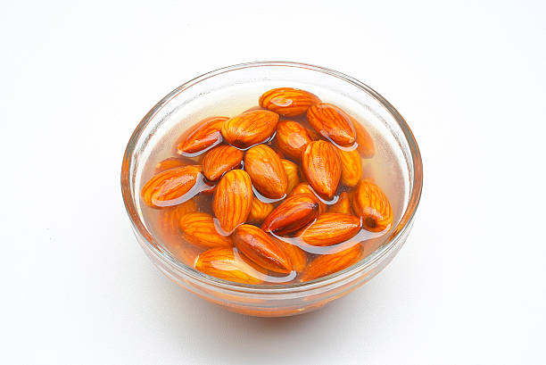 Closeup of almonds soaked in water stock photo