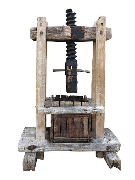 istock Ancient wooden wine old press isolated on white 614865710