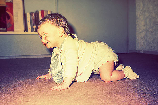 istock Vintage baby boy crawling 614866918