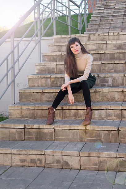 istock Beautiful girl  sitting on the stone steps 614867106